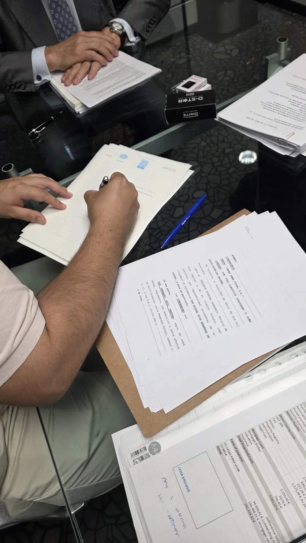 Signing the final paperwork at the notary